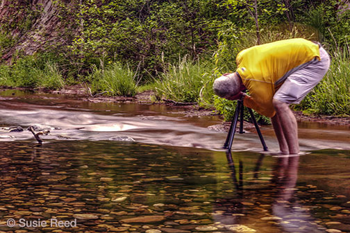 Susiue Reed's photo student taking picture in creek